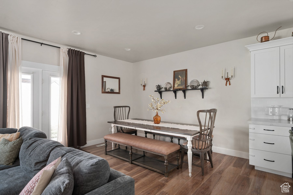 Dining room with baseboards and dark wood finished floors