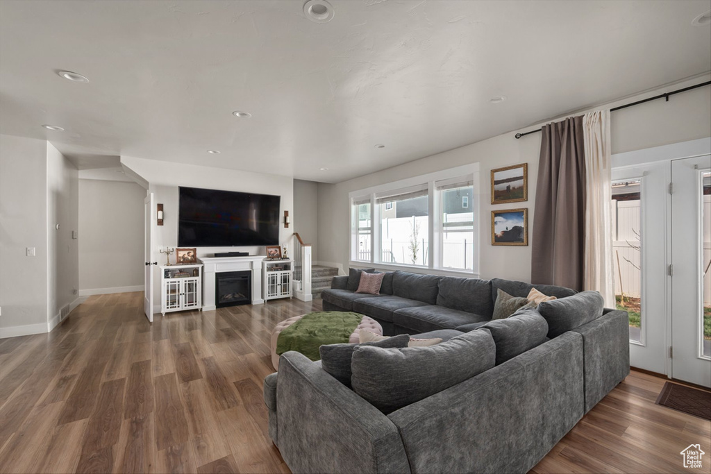Living room featuring wood finished floors, baseboards, and recessed lighting