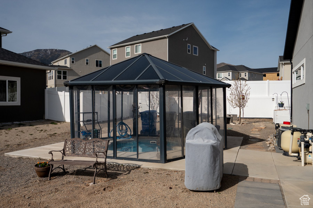 Exterior space with a fenced backyard, a fenced in pool, a residential view, and a patio area