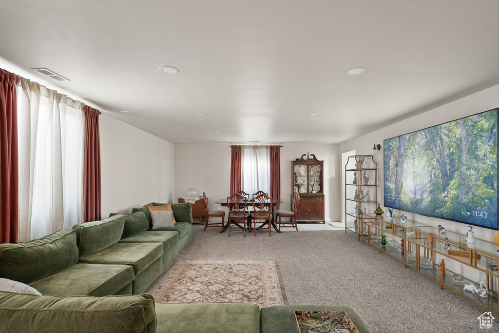 Carpeted living area with visible vents