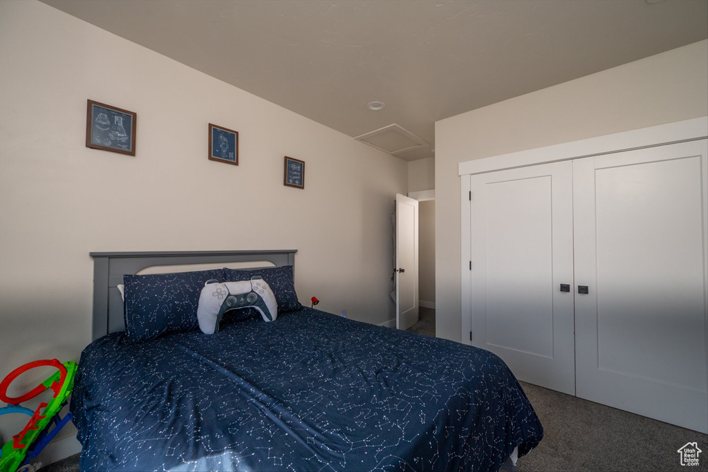 Bedroom featuring carpet and attic access