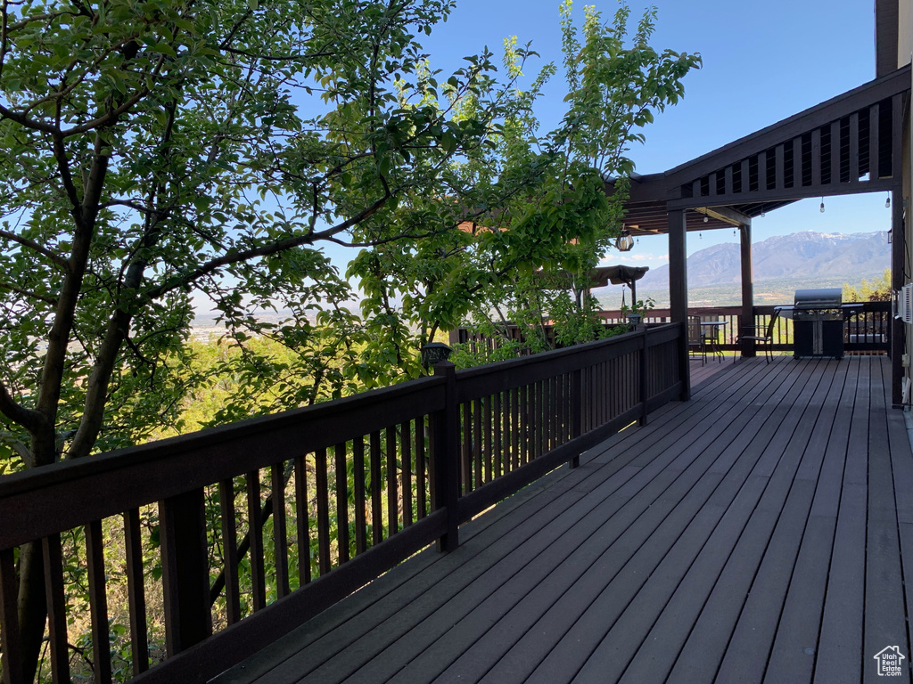 Deck featuring a mountain view and area for grilling