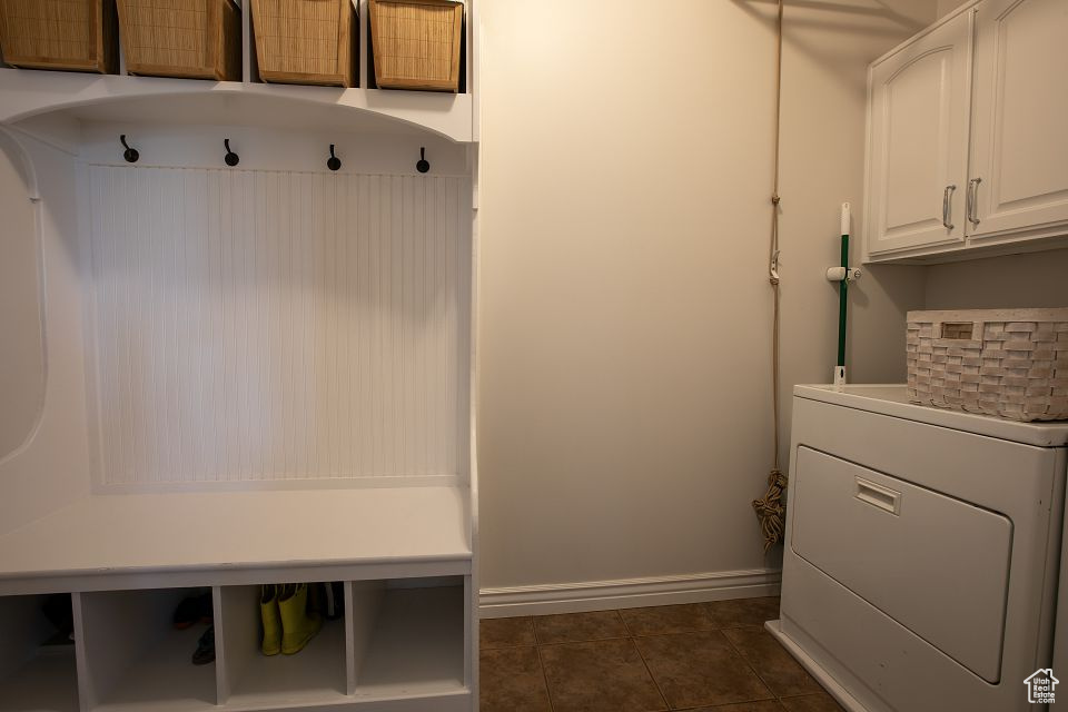 Mudroom with washer / dryer and dark tile patterned flooring