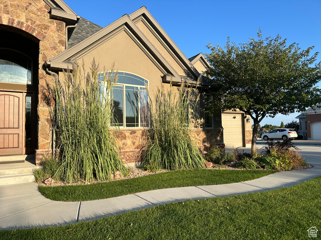 View of side of property with stucco siding and stone siding