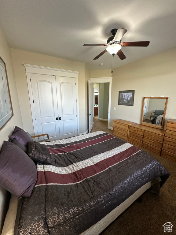 Bedroom with carpet flooring, a closet, and a ceiling fan