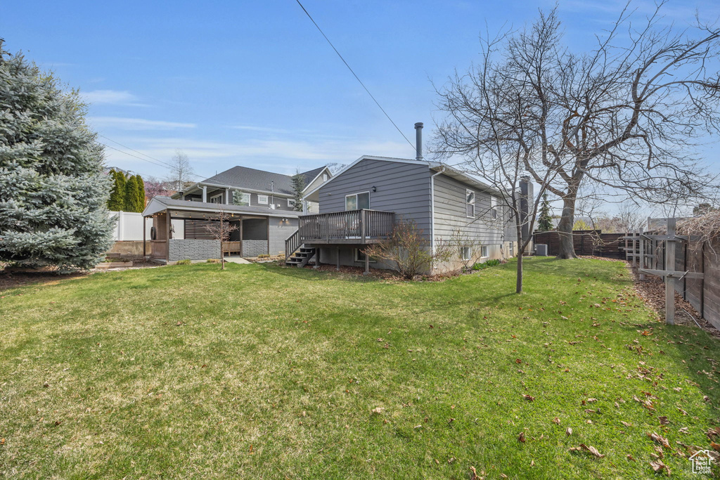 Exterior space featuring fence, stairway, and a deck