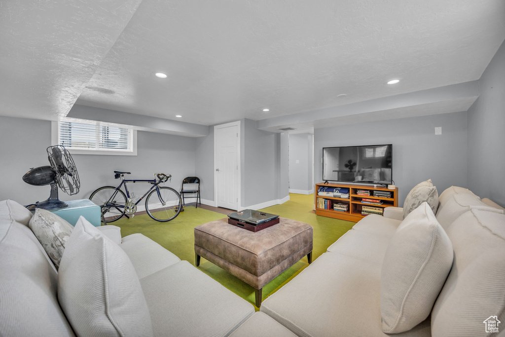 Living area featuring baseboards, recessed lighting, and a textured ceiling