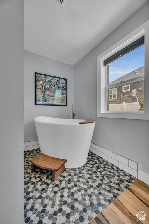 Bathroom with a freestanding bath and baseboards