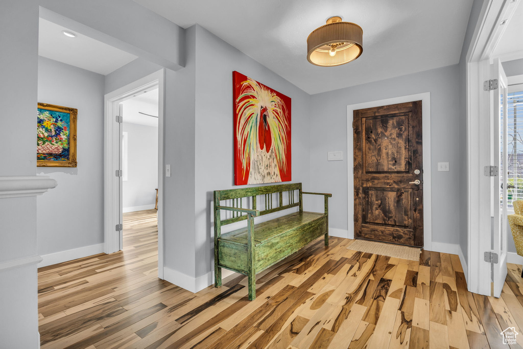 Foyer with light wood-style flooring and baseboards