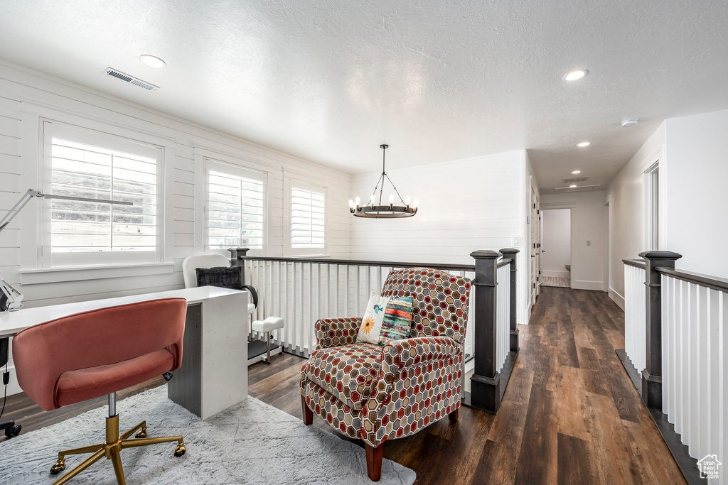 Office space with a chandelier, wood finished floors, recessed lighting, and a textured ceiling