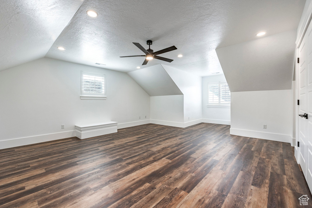 Bonus room featuring lofted ceiling, dark wood-type flooring, a ceiling fan, a textured ceiling, and recessed lighting