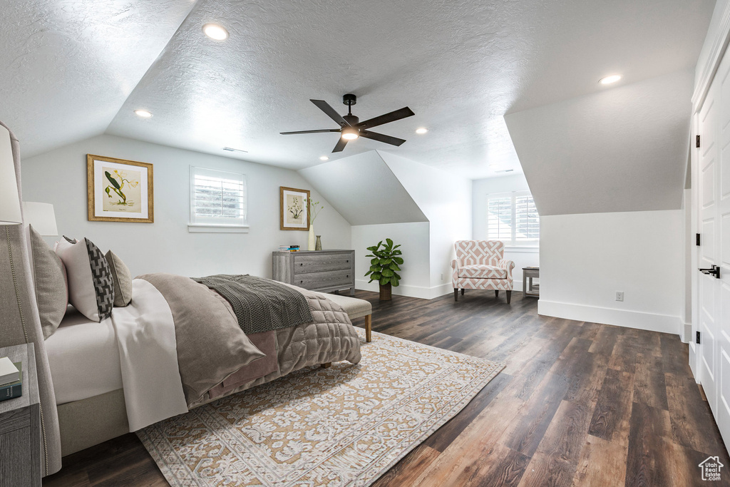 Bedroom featuring lofted ceiling, dark wood finished floors, a textured ceiling, recessed lighting, and a ceiling fan