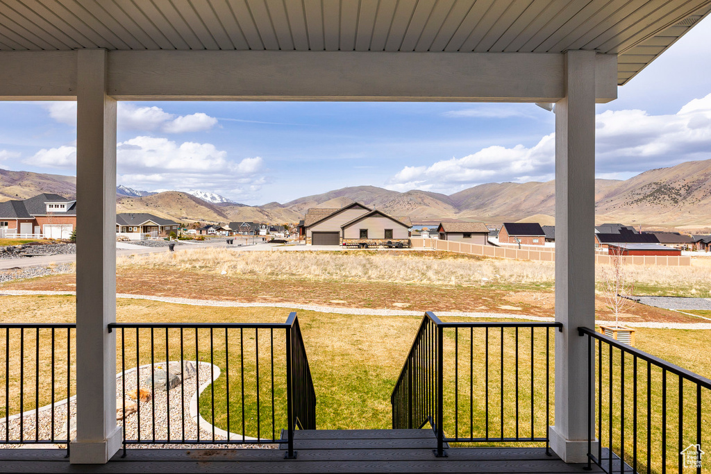 Deck featuring a mountain view, a residential view, and a lawn