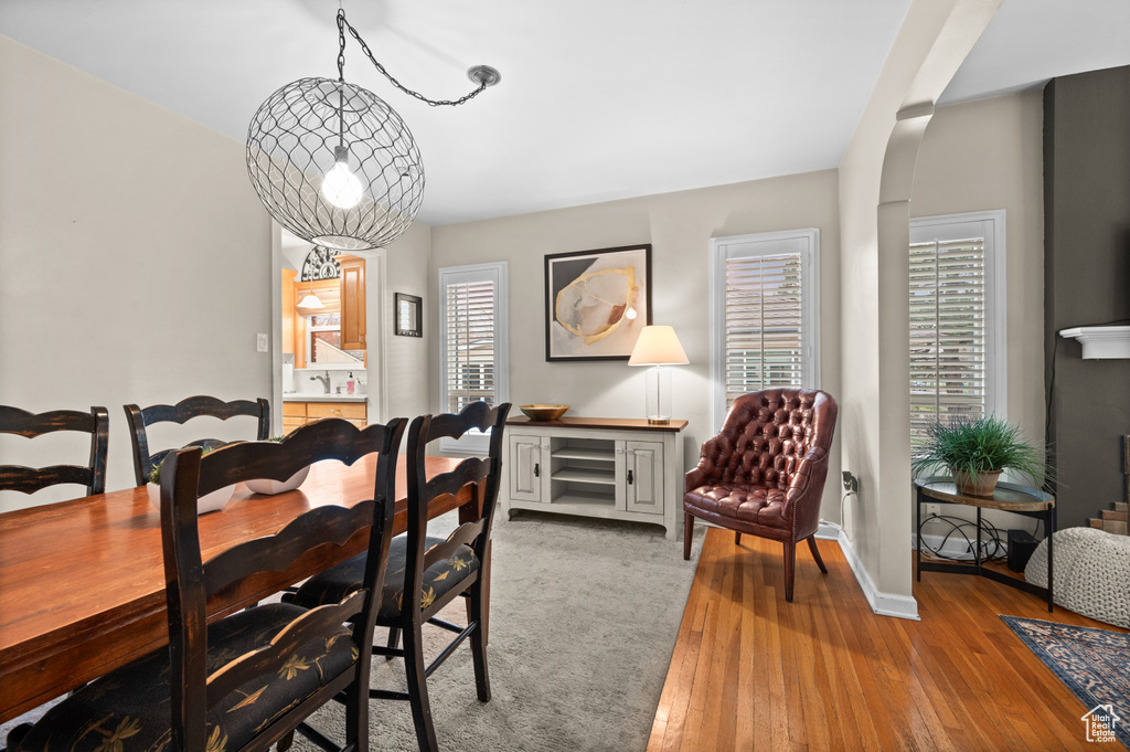 Dining area with a wealth of natural light, hardwood / wood-style floors, and baseboards