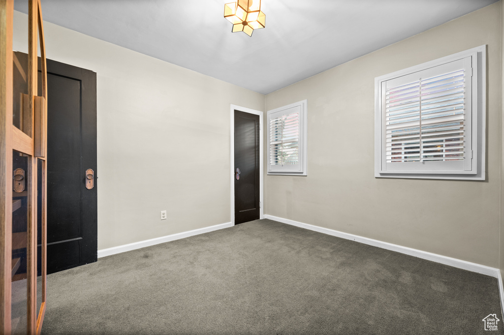 Carpeted spare room with baseboards