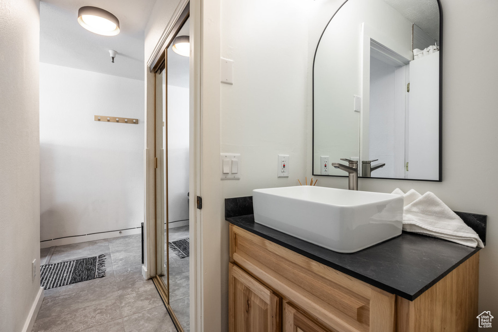 Bathroom featuring visible vents, baseboards, and vanity