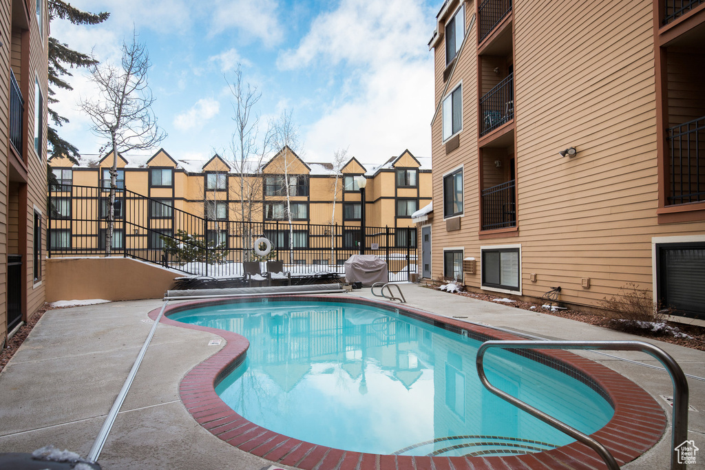 Community pool with fence and area for grilling
