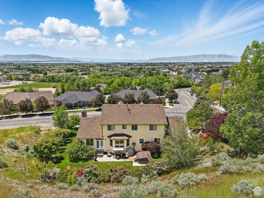 Aerial view of property and surrounding area with mountains