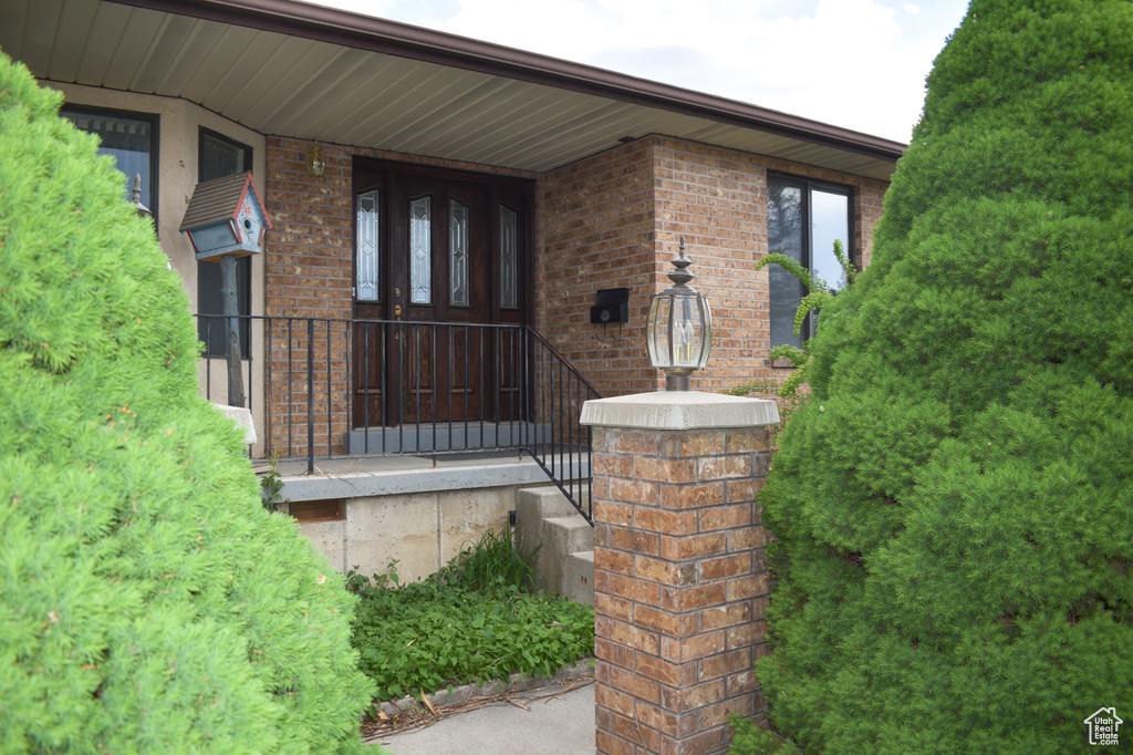 Doorway to property with brick siding