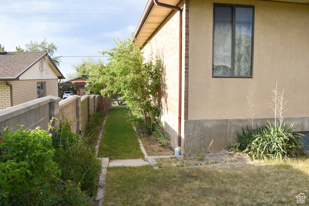 View of property exterior with stucco siding and brick siding