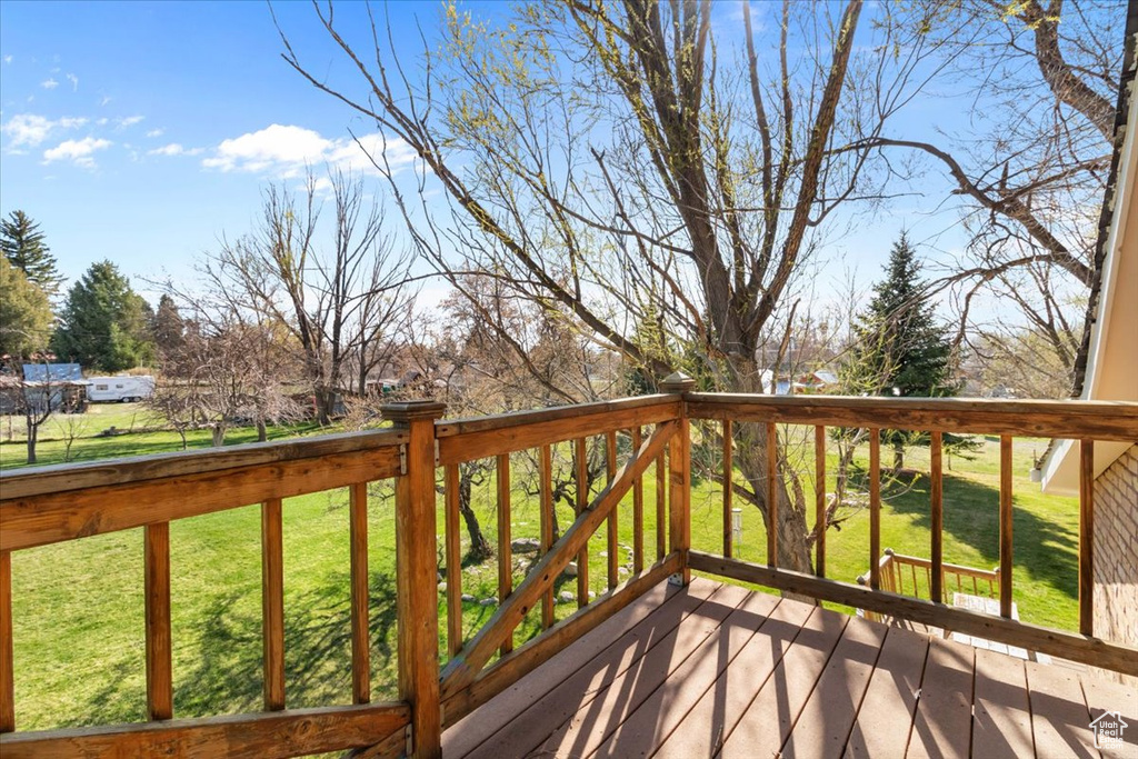 Wooden terrace featuring a lawn