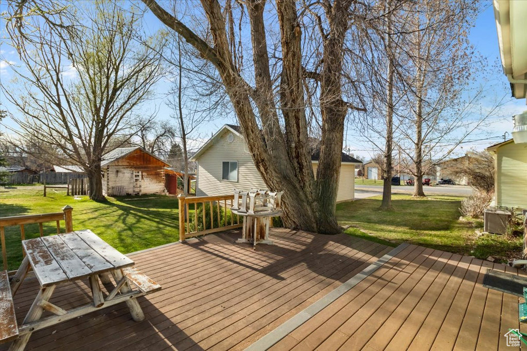 Wooden terrace with a yard and outdoor dining space