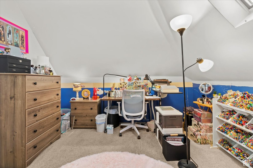 Carpeted office space with lofted ceiling