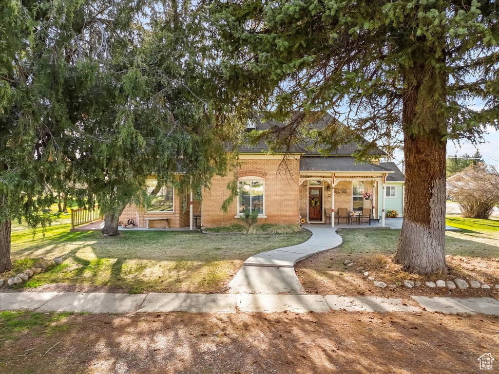 View of front facade featuring a front lawn and brick siding