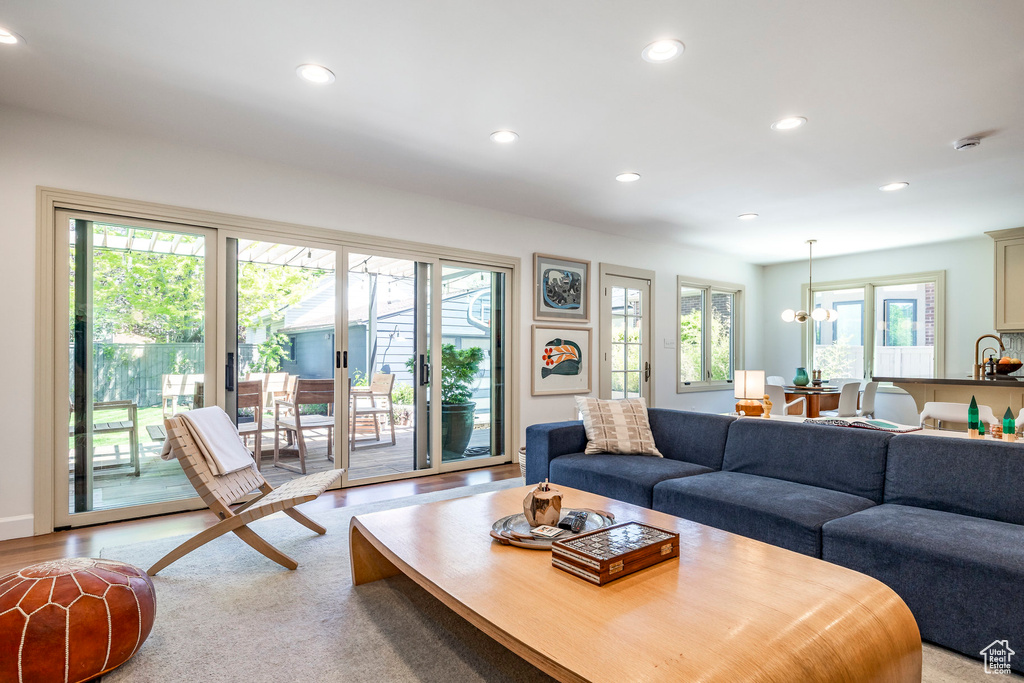 Living area featuring recessed lighting, plenty of natural light, and a chandelier