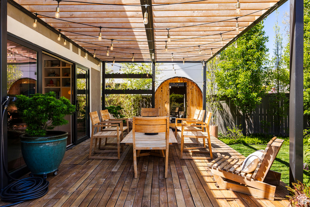 Deck featuring a pergola and fence