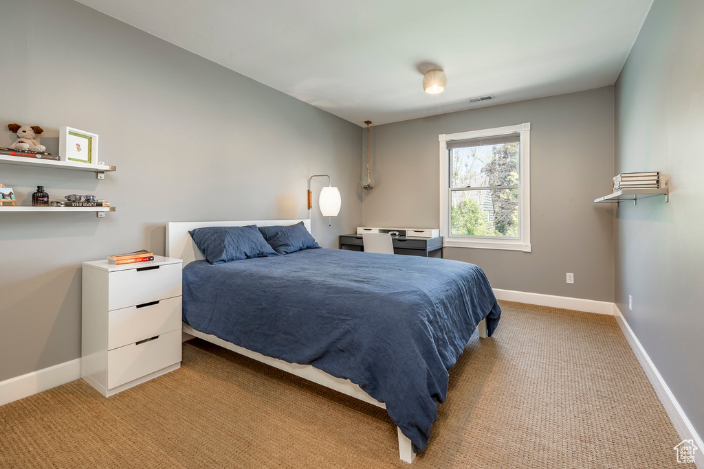 Bedroom featuring baseboards and light colored carpet