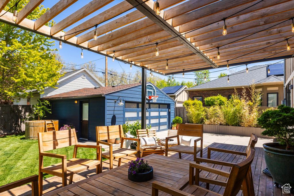 Wooden terrace with an outbuilding, an outdoor living space, a pergola, and a garage