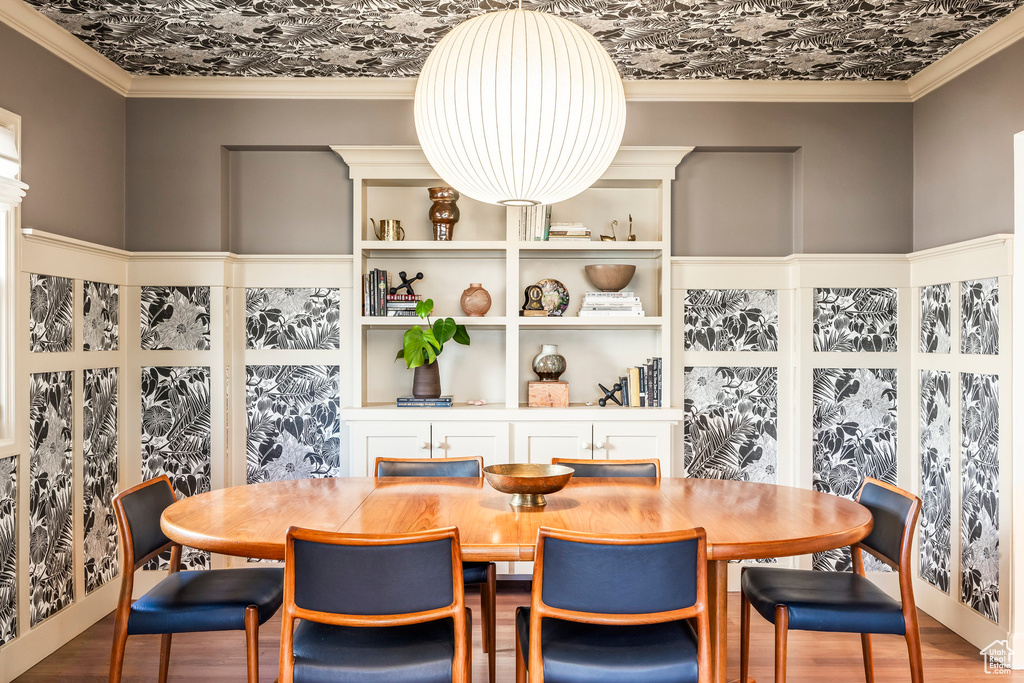 Dining area featuring crown molding and wood finished floors