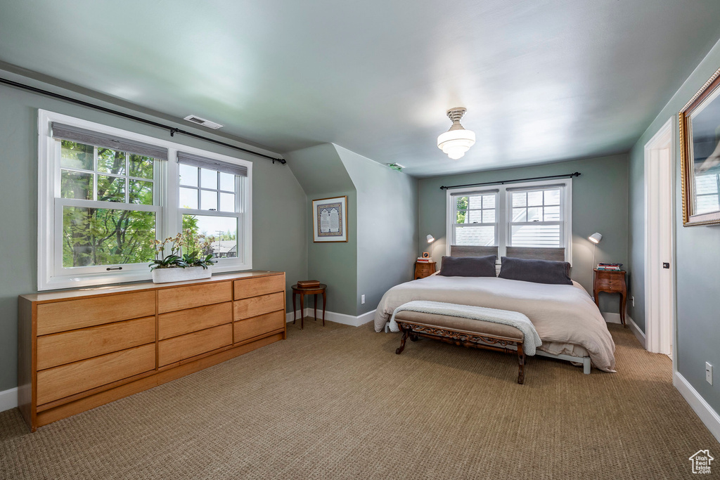 Bedroom featuring light colored carpet and baseboards
