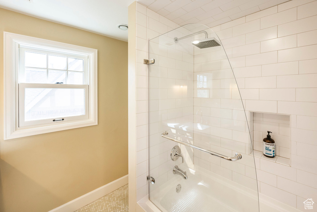 Bathroom with baseboards and shower / washtub combination