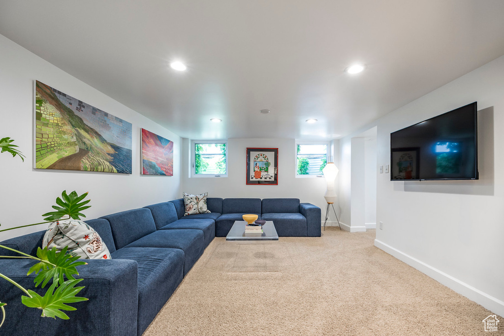 Carpeted living area featuring baseboards and recessed lighting