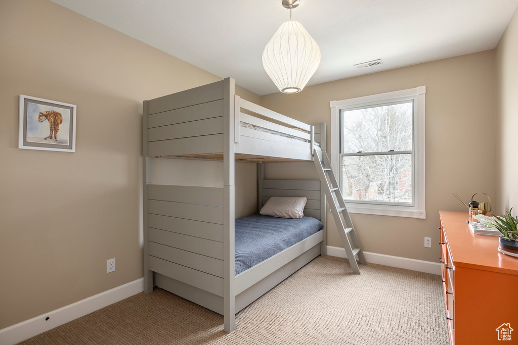 Bedroom featuring baseboards and light colored carpet