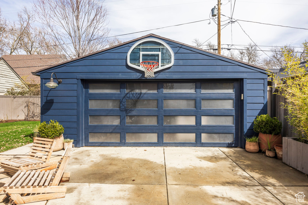 Garage with fence and driveway