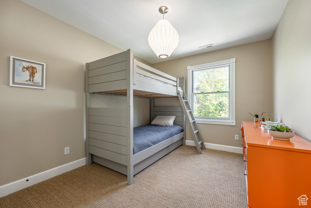 Bedroom featuring light carpet and baseboards