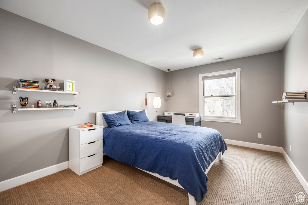 Bedroom with baseboards, light carpet, and visible vents