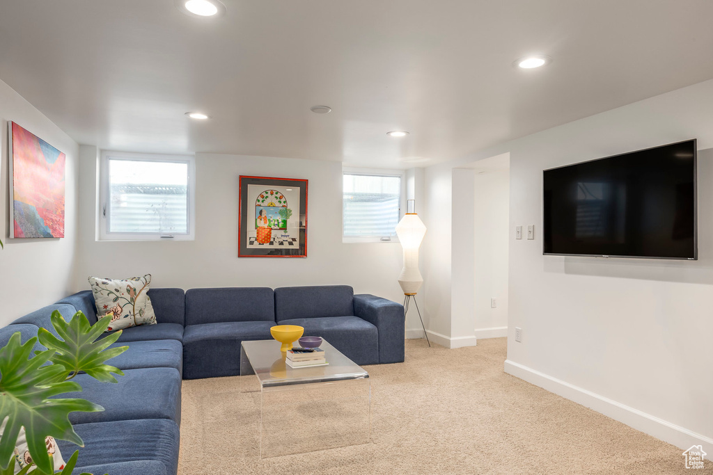Carpeted living room with recessed lighting, baseboards, and a wealth of natural light