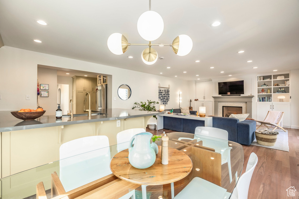 Dining room featuring recessed lighting, wood finished floors, and a fireplace