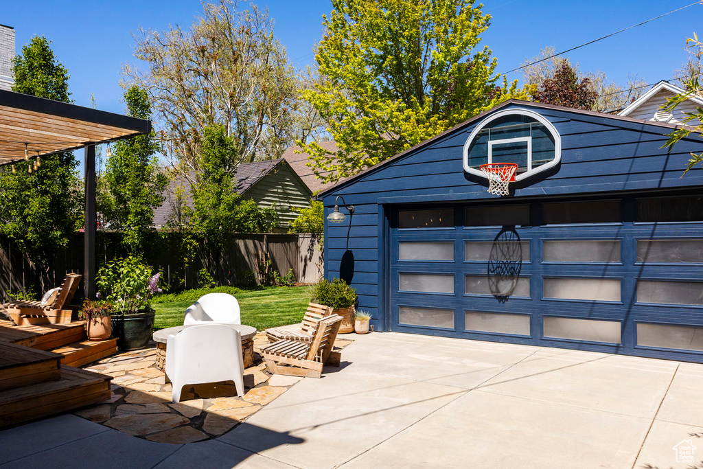 Garage featuring fence and driveway