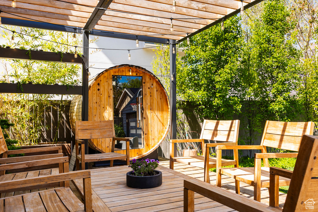 Wooden deck with a pergola and an outdoor structure