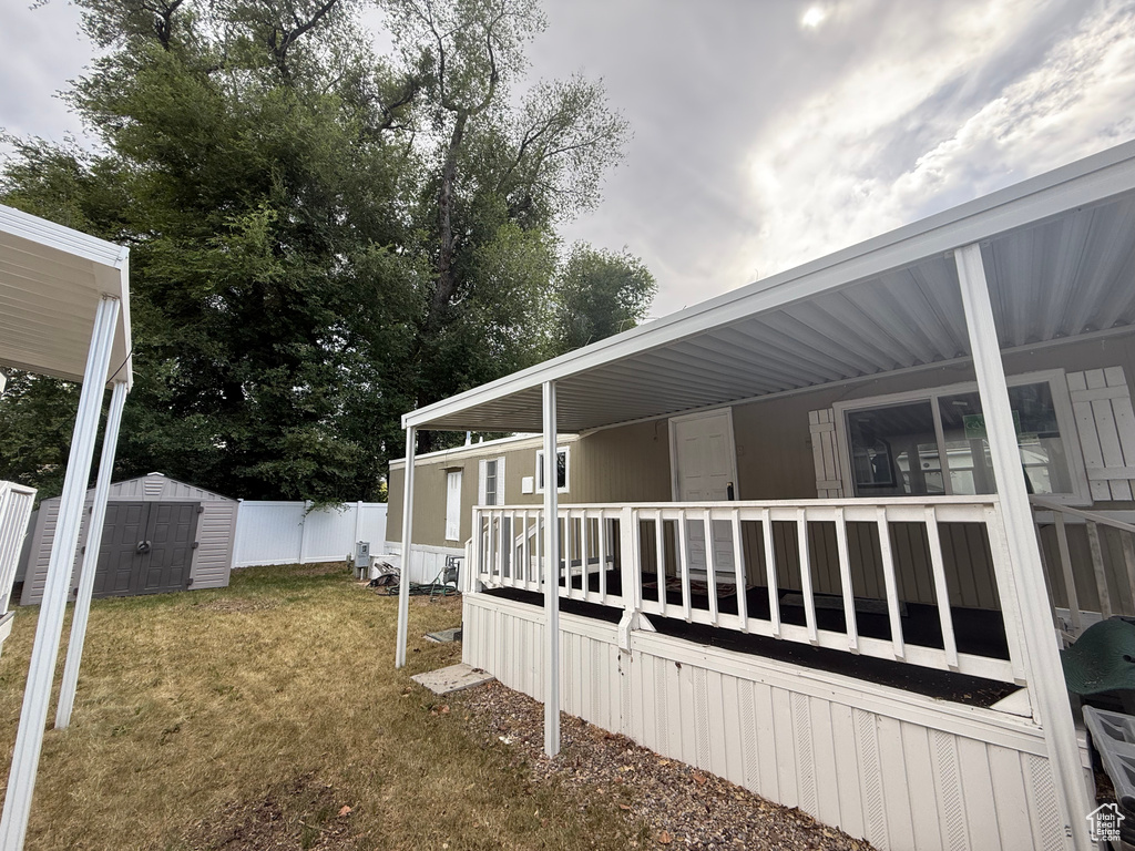 View of side of home with a wooden deck