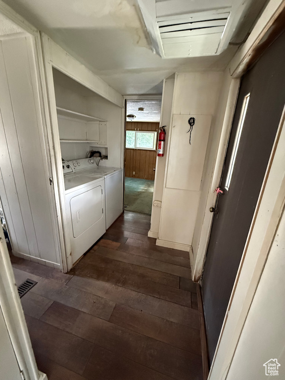 Hallway featuring dark wood-type flooring and washing machine and clothes dryer