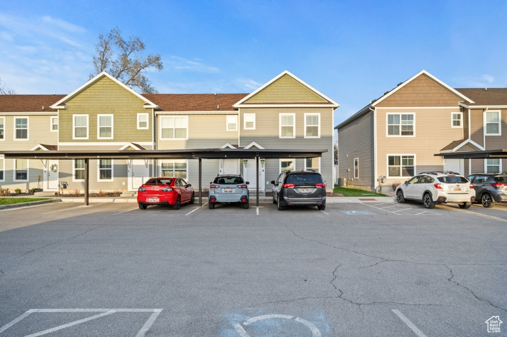 Partially covered parking lot featuring a residential view
