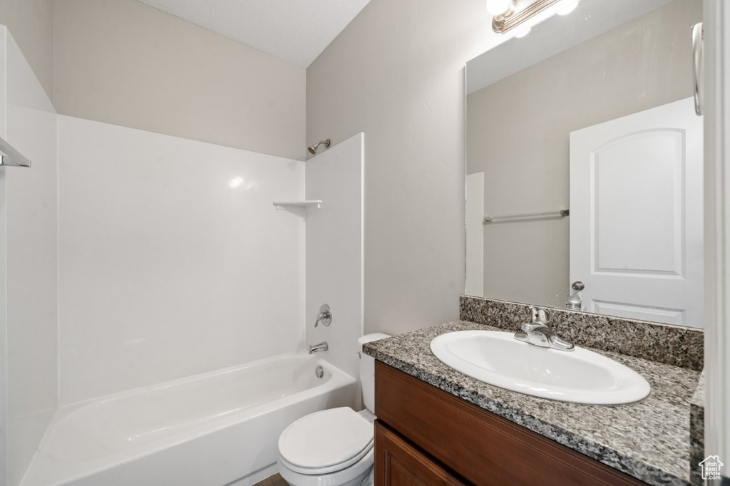 Full bathroom featuring vanity,  shower combination, and toilet