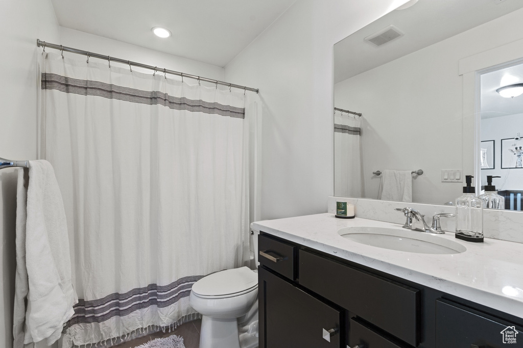 Full bathroom featuring toilet and vanity