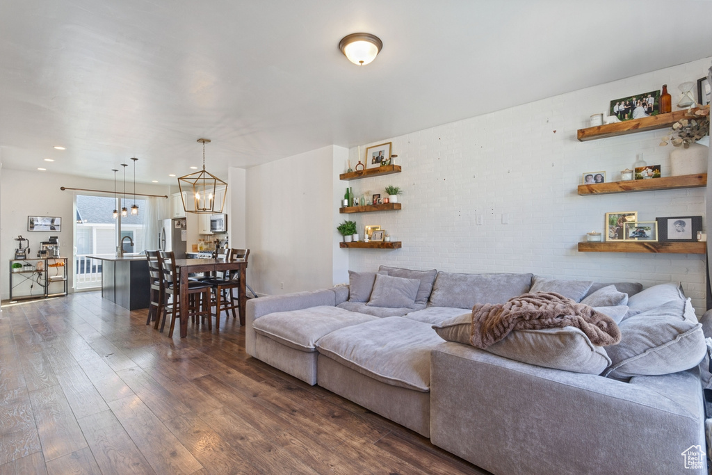 Living area featuring dark wood finished floors and a chandelier